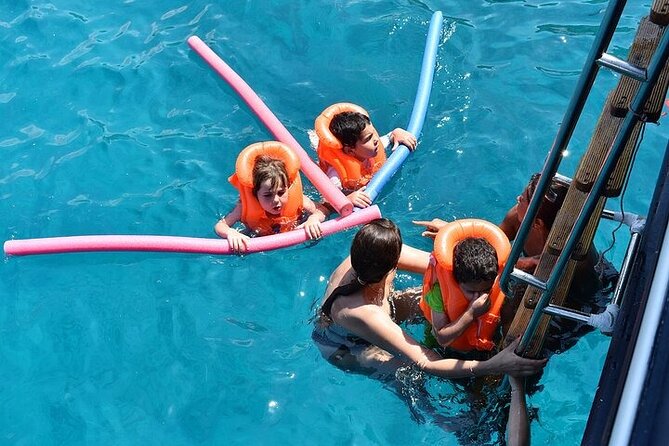 Athens Riviera Half-Day Cruise – Swim, Lunch & Drinks Included! - Athens Riviera cruise comfort: crew energy, music, and onboard basics
