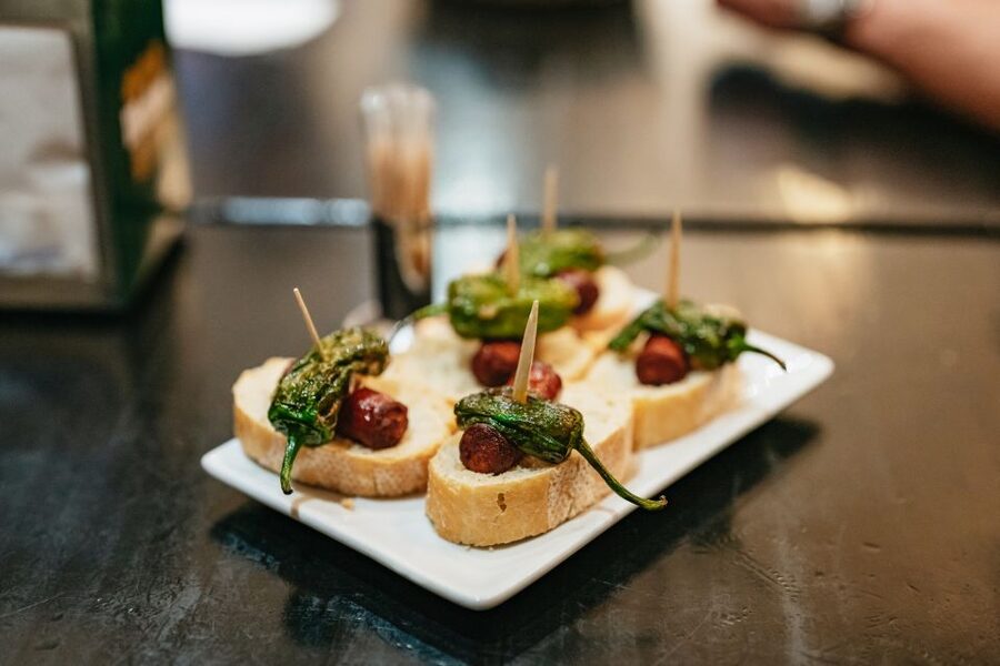 Madrid: Food & Wine Tour with 10 Tapas & 4 Drinks Included - Stop 1: A Market-Style Meal That Sets the Flavor Direction